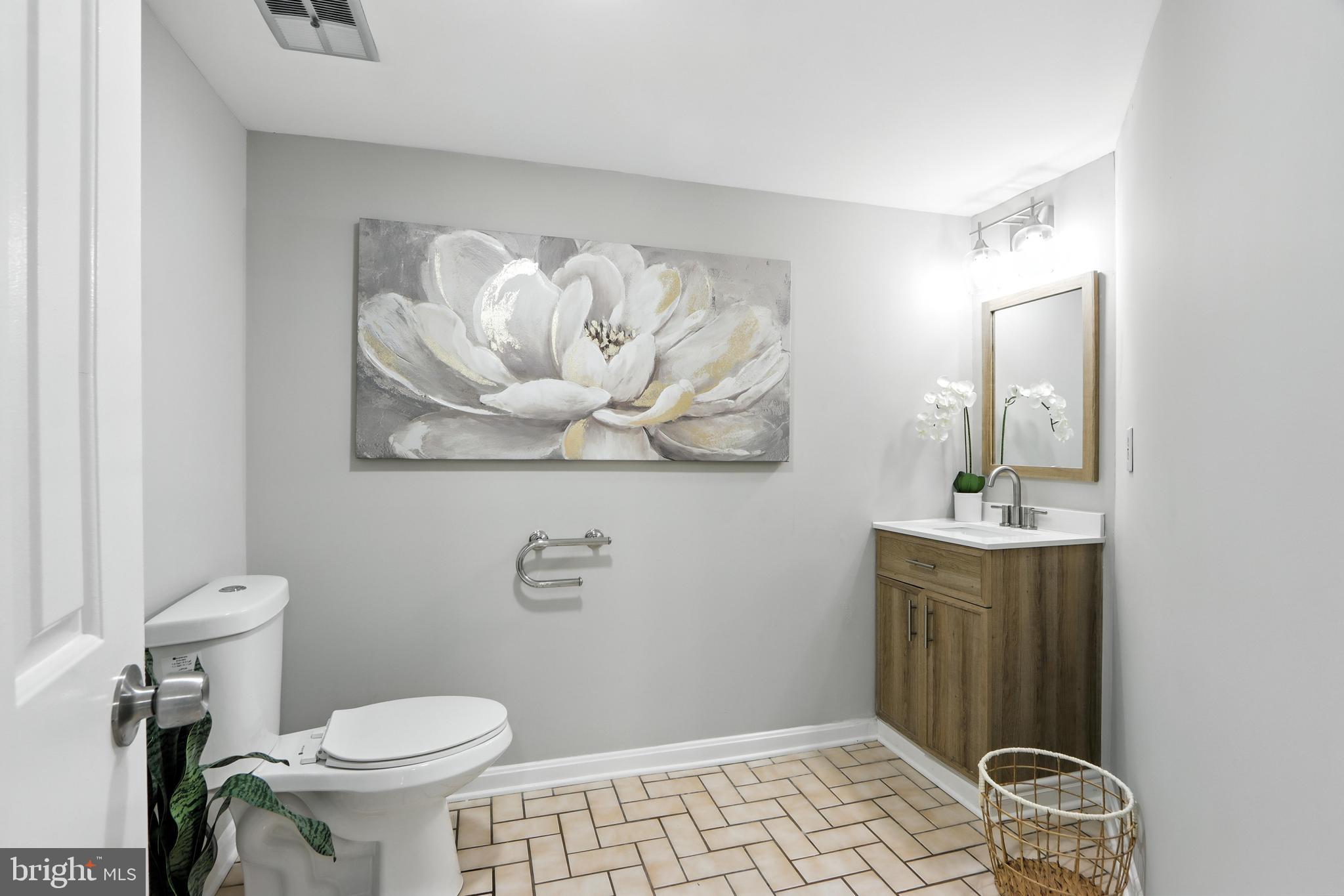 3005 Courtside Road Bowie, MD 20721 - Photo 13 of 43 a bathroom with a sink a toilet and mirror