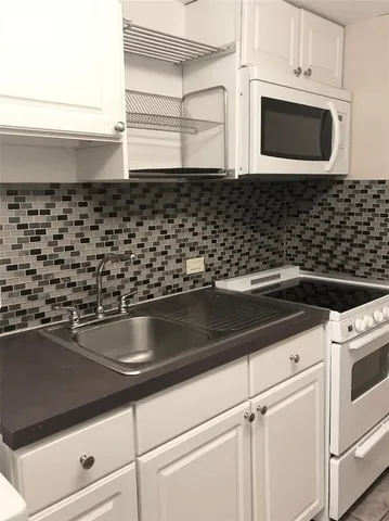 a close view of a stove a microwave oven on the wall