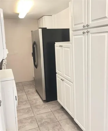 a white refrigerator freezer and a stove sitting inside of a kitchen