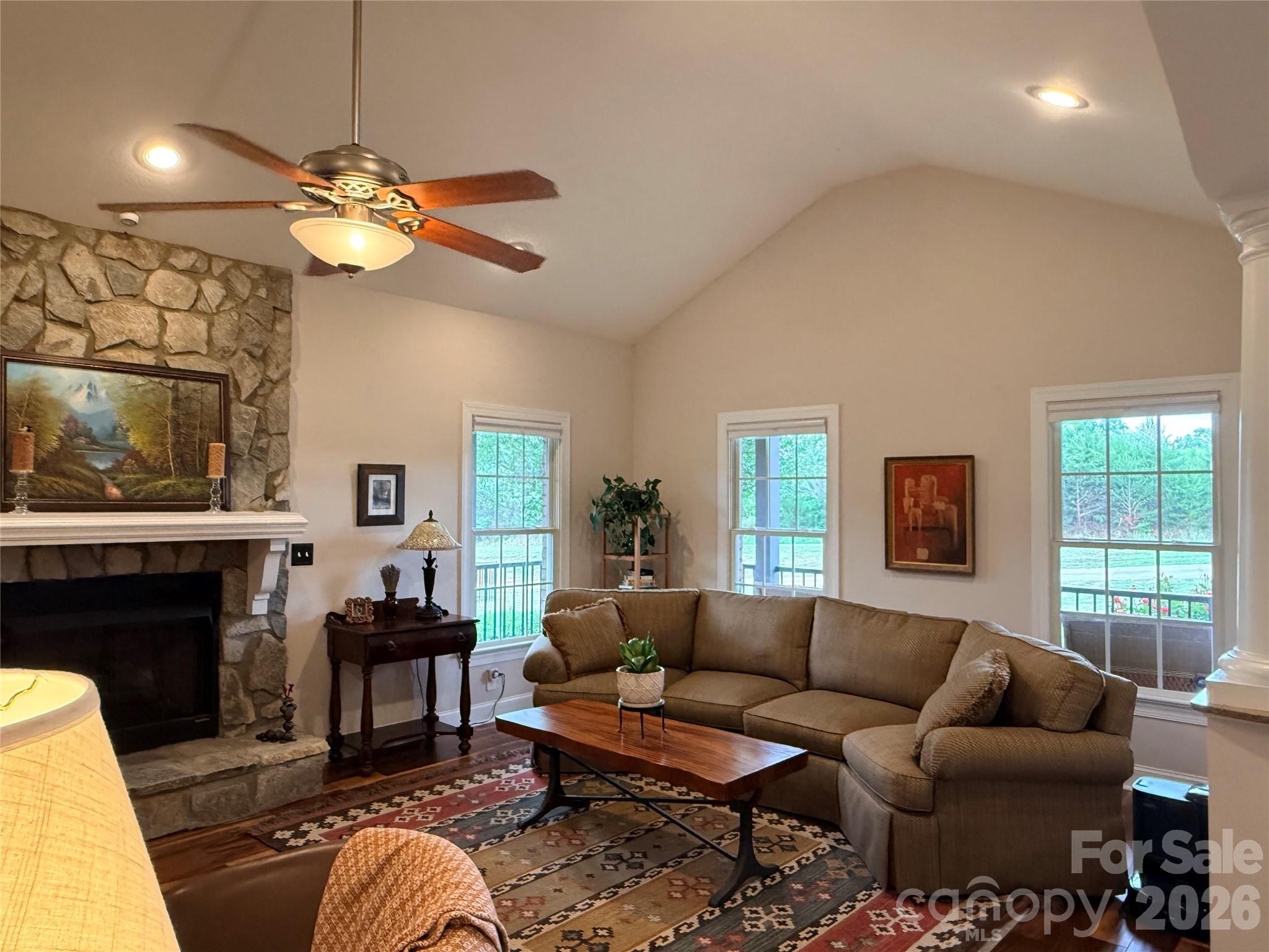 183 Burl Bridges Road Forest City, NC 28043 - Photo 7 of 31 a living room with furniture a fireplace and a large window