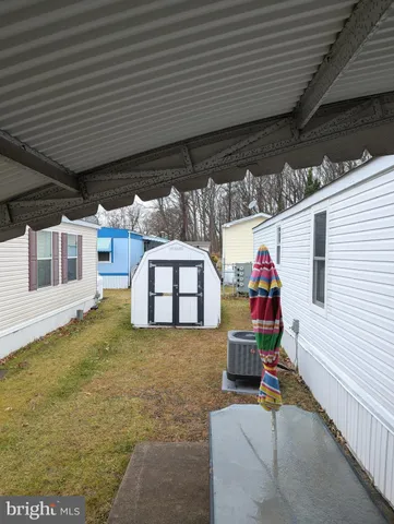a view of a porch with furniture and floor to ceiling window