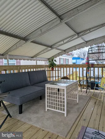 a view of a roof deck with a table and chairs