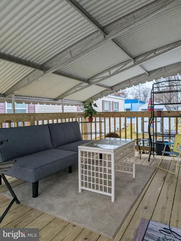 a view of a roof deck with a table and chairs
