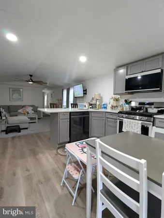 a kitchen with a sink a microwave and cabinets