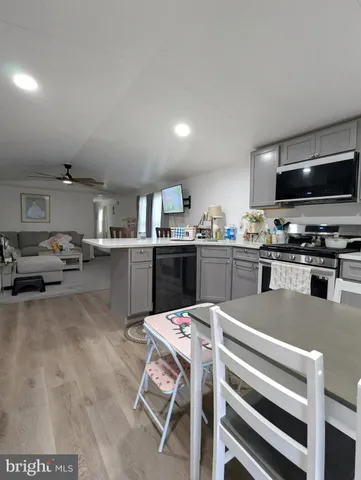 a kitchen with a sink a microwave and cabinets