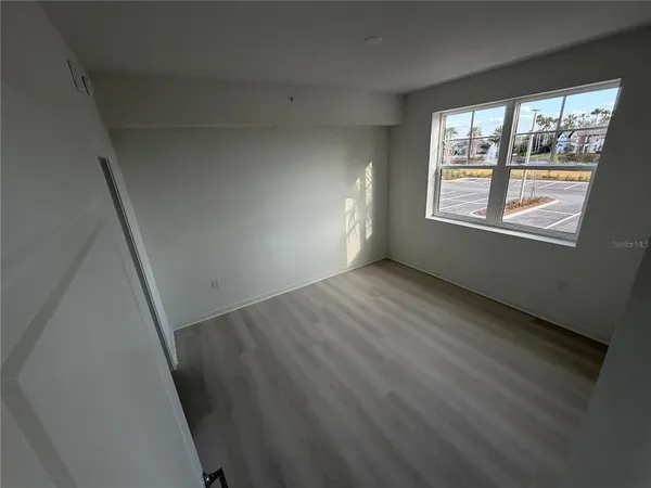 a view of an empty room with a window