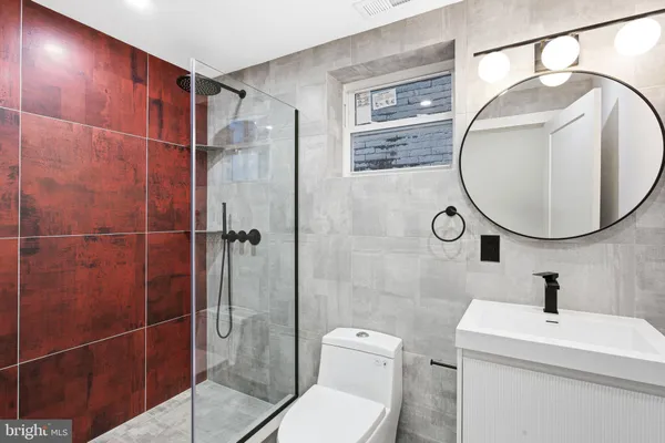 a bathroom with a toilet a sink and a mirror