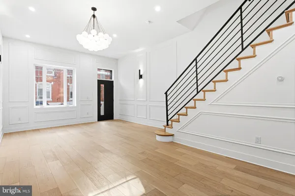 a view of entryway and hall with wooden floor