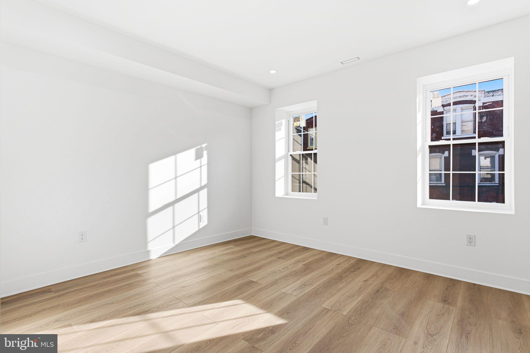 1419 Wharton Street Philadelphia, PA 19146 - Photo 21 of 39 an empty room with wooden floor and windows