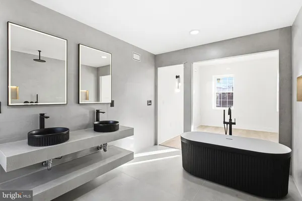 a room with a sink and a mirror