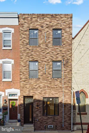 a view of a brick house with large windows