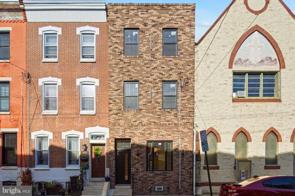 a view of a brick house with many windows
