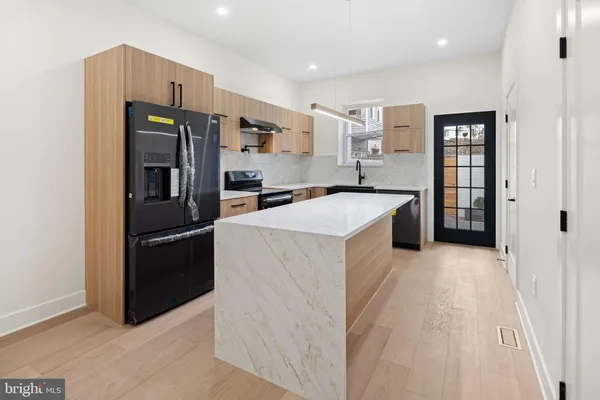 a kitchen with stainless steel appliances a refrigerator and a stove