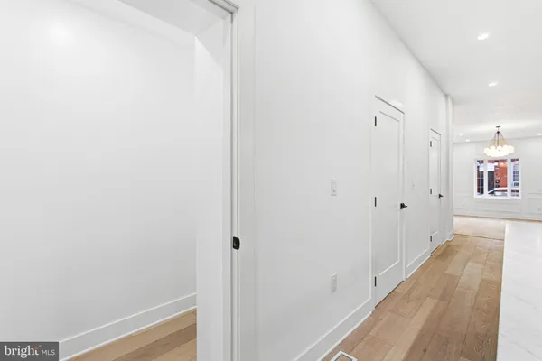 a view of a hallway with wooden floor
