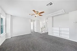 a view of empty room with wooden floor and windows