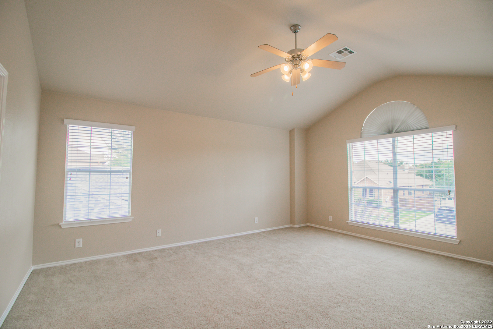2621 Pillory Pointe Schertz, TX 78108 - Photo 14 of 25 an empty room with chandelier fan and windows
