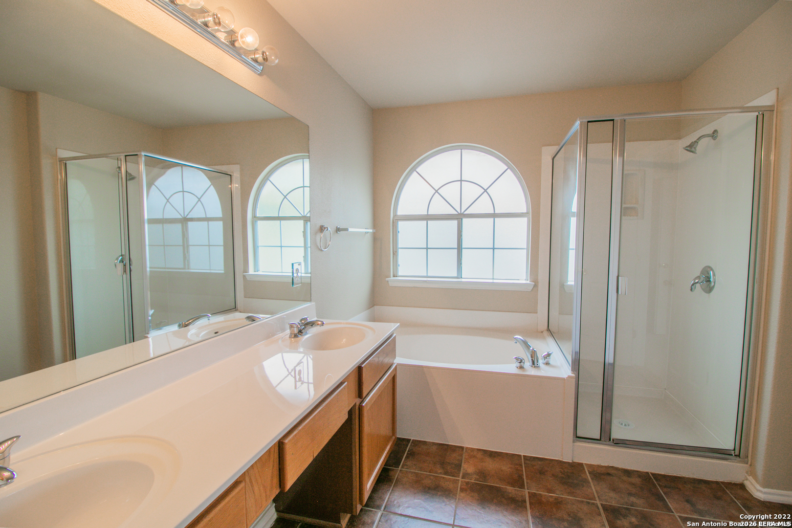 2621 Pillory Pointe Schertz, TX 78108 - Photo 15 of 25 a spacious bathroom with a bathtub a sink and a large mirror
