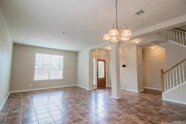 a view of a chandelier in big room and chandelier
