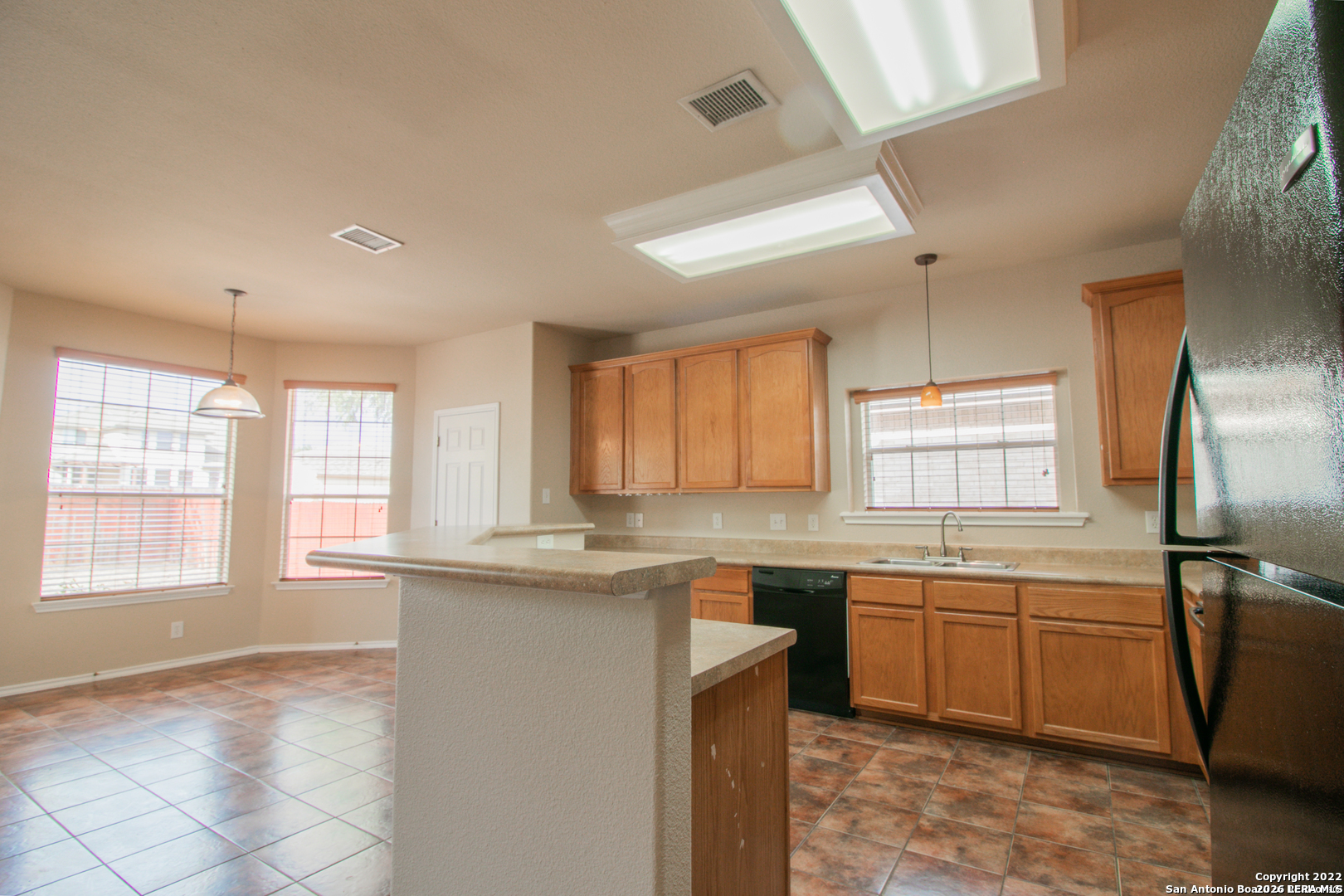 2621 Pillory Pointe Schertz, TX 78108 - Photo 10 of 25 a kitchen with a sink window and cabinets