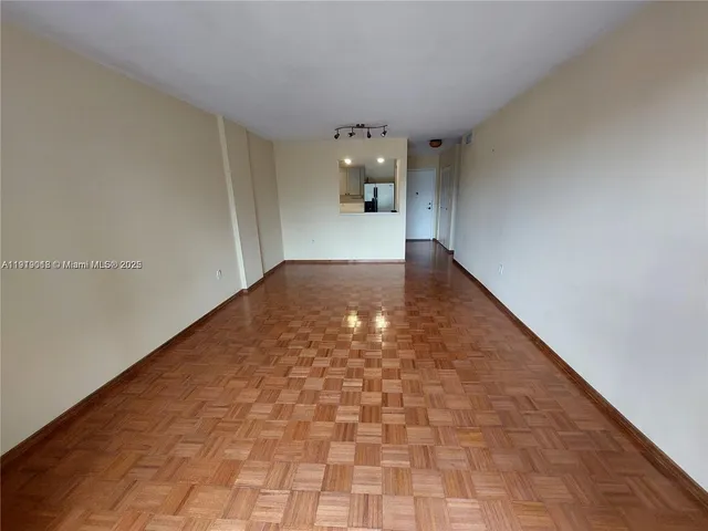 a view of a big room with wooden floor and staircase