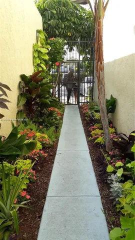 a narrow alley with flowers