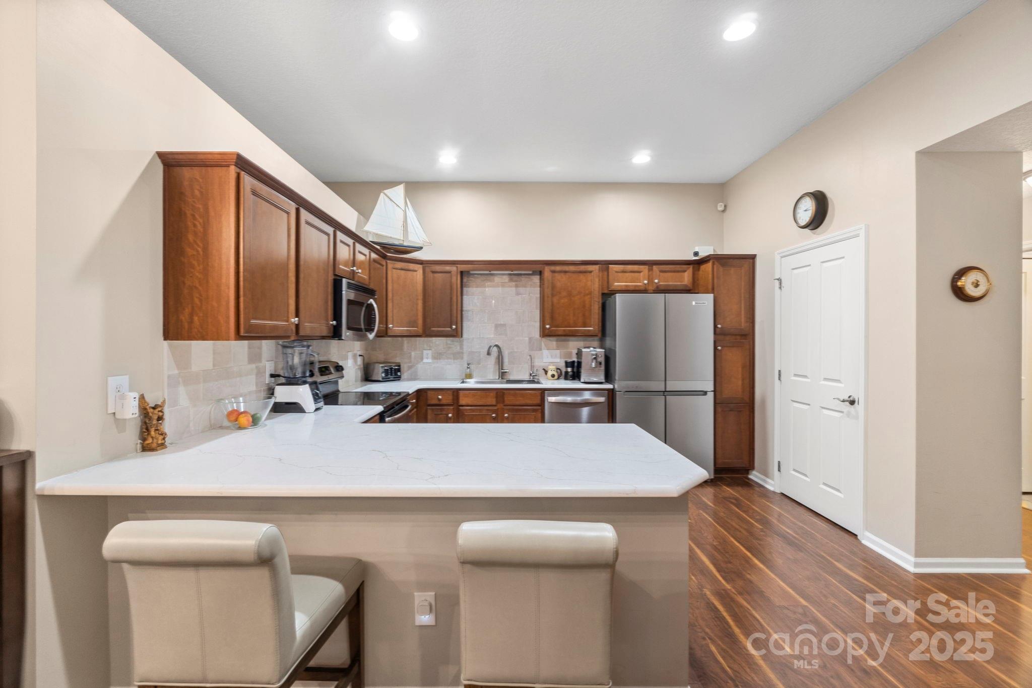 2459 Coltsview Lane Matthews, NC 28105 - Photo 8 of 31 a kitchen with a sink a refrigerator and cabinets