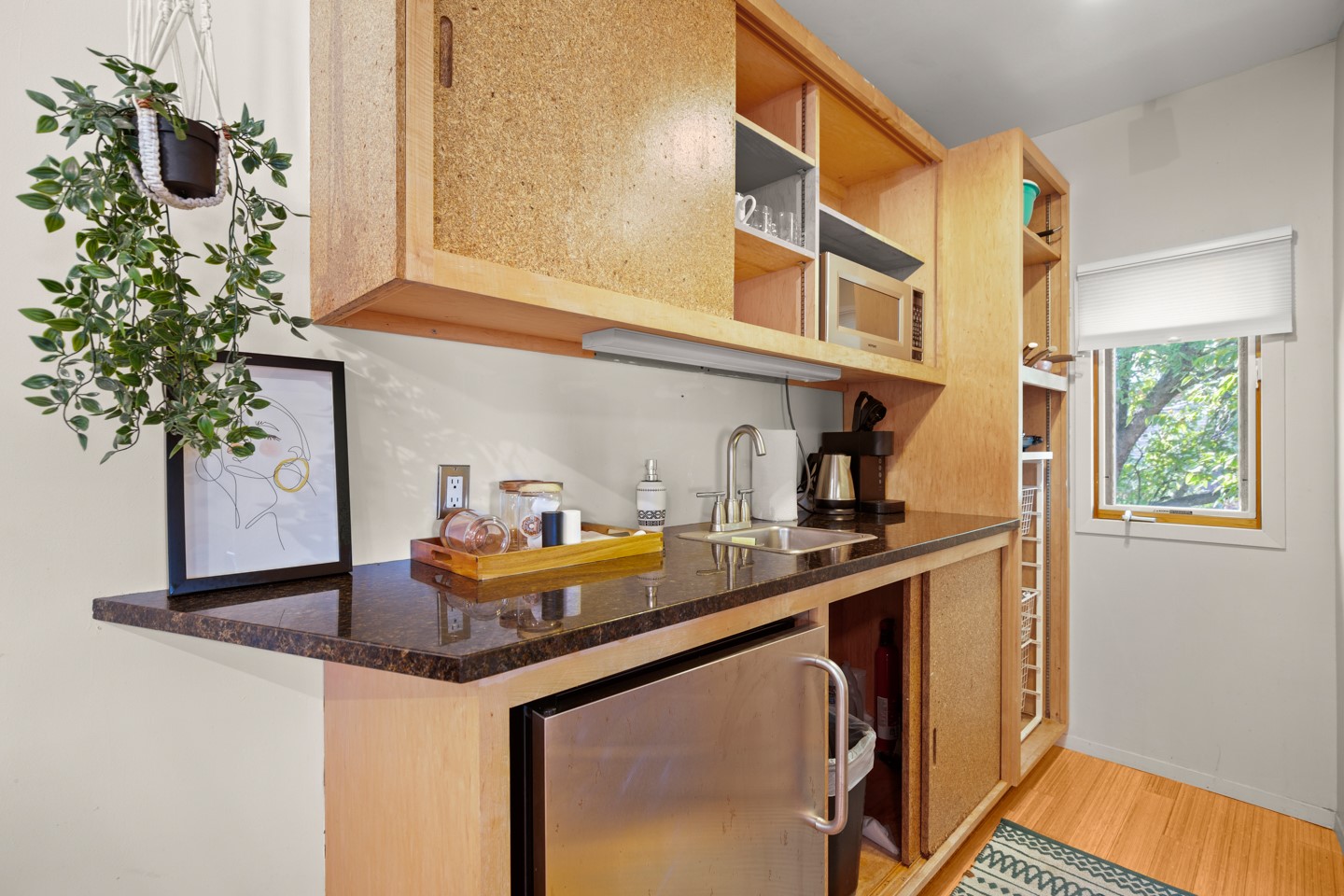 1406 Summit Street Austin, TX 78741 - Photo 30 of 32 a kitchen with a sink and a potted plant next to a window