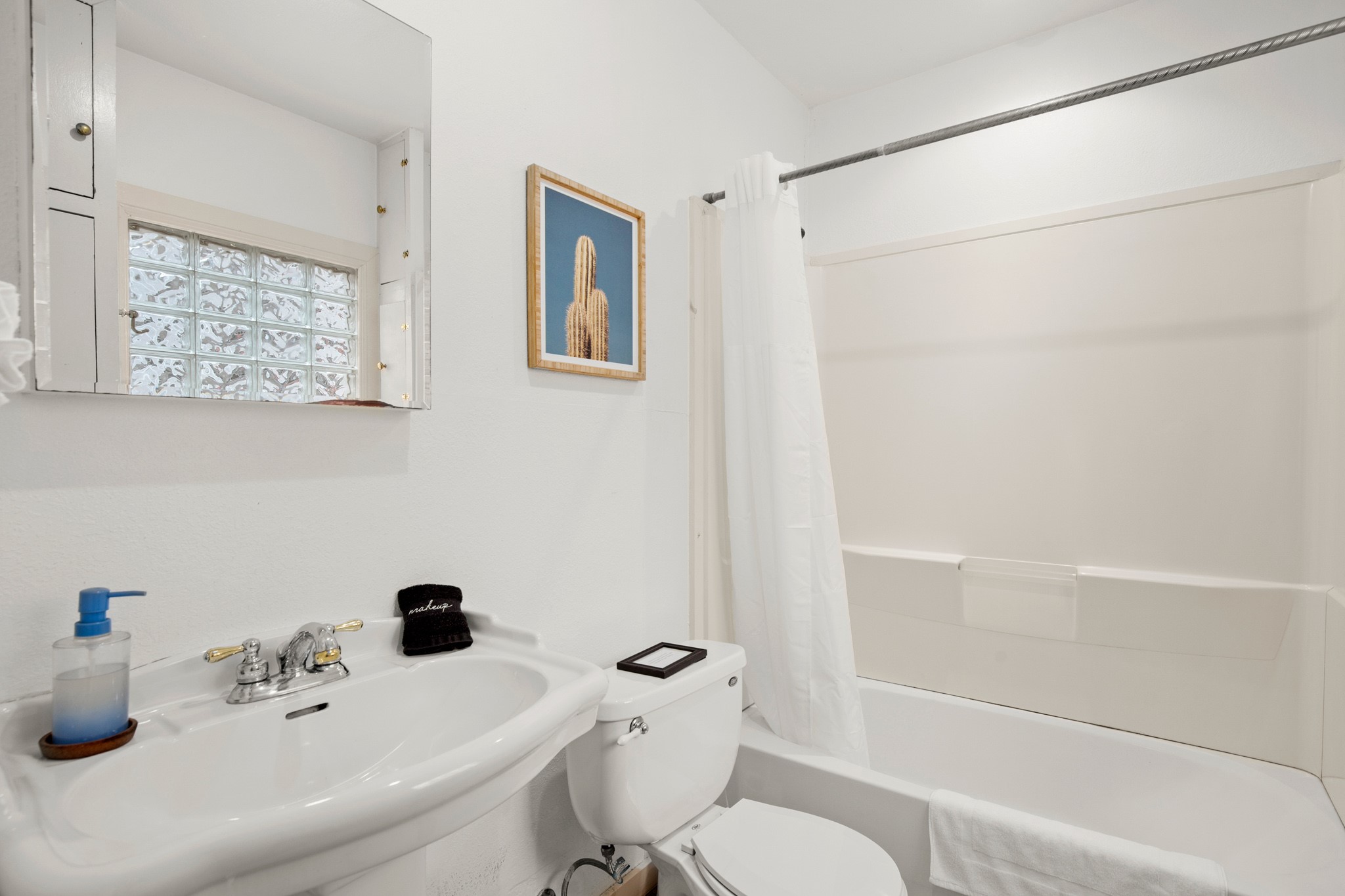 1406 Summit Street Austin, TX 78741 - Photo 10 of 32 a bathroom with a sink a toilet and shower