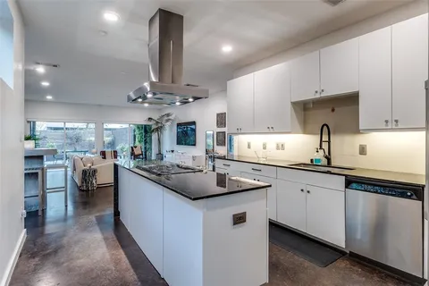 a kitchen with stainless steel appliances a sink stove and cabinets