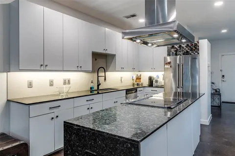 a kitchen with stainless steel appliances granite countertop a sink and cabinets