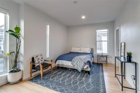 a bedroom with a bed and a potted plant