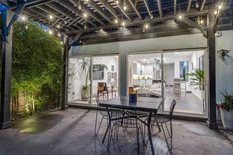 a dining room with furniture and a floor to ceiling window