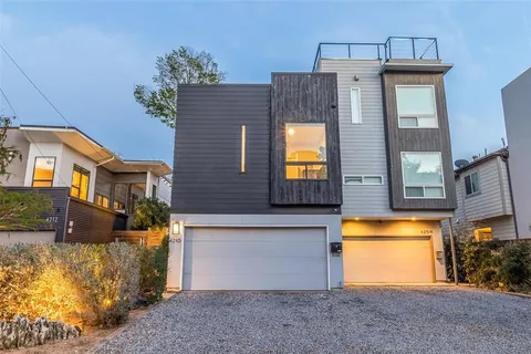 a view of a house with a tub and potted plants