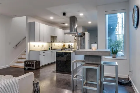 a kitchen with a sink stainless steel appliances and cabinets