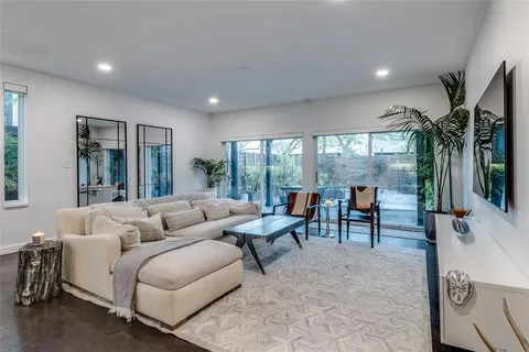 a living room with furniture and large windows