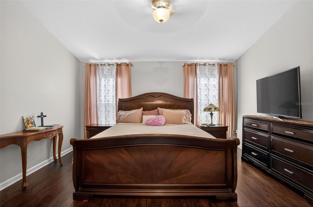 11519 Misty Isle Lane Riverview, FL 33579 - Photo 13 of 27 a bedroom with a bed and a flat screen tv