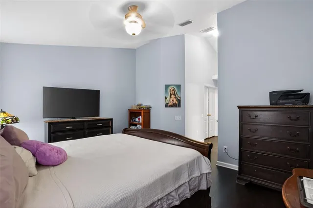 a bedroom with a bed and a flat screen tv