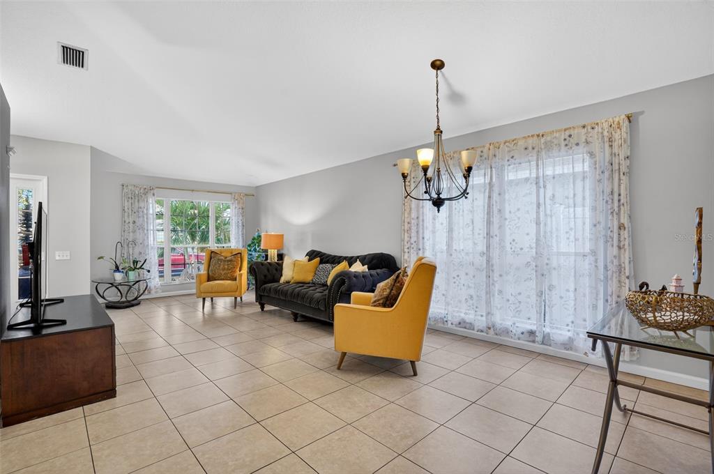 11519 Misty Isle Lane Riverview, FL 33579 - Photo 5 of 27 a living room with furniture and a chandelier