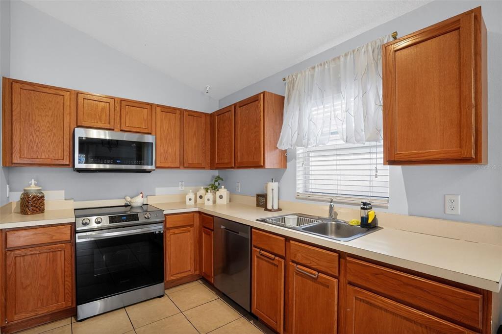 11519 Misty Isle Lane Riverview, FL 33579 - Photo 7 of 27 a kitchen with a sink a stove and cabinets