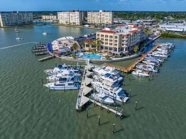 a large body of water next to a building with outdoor seating