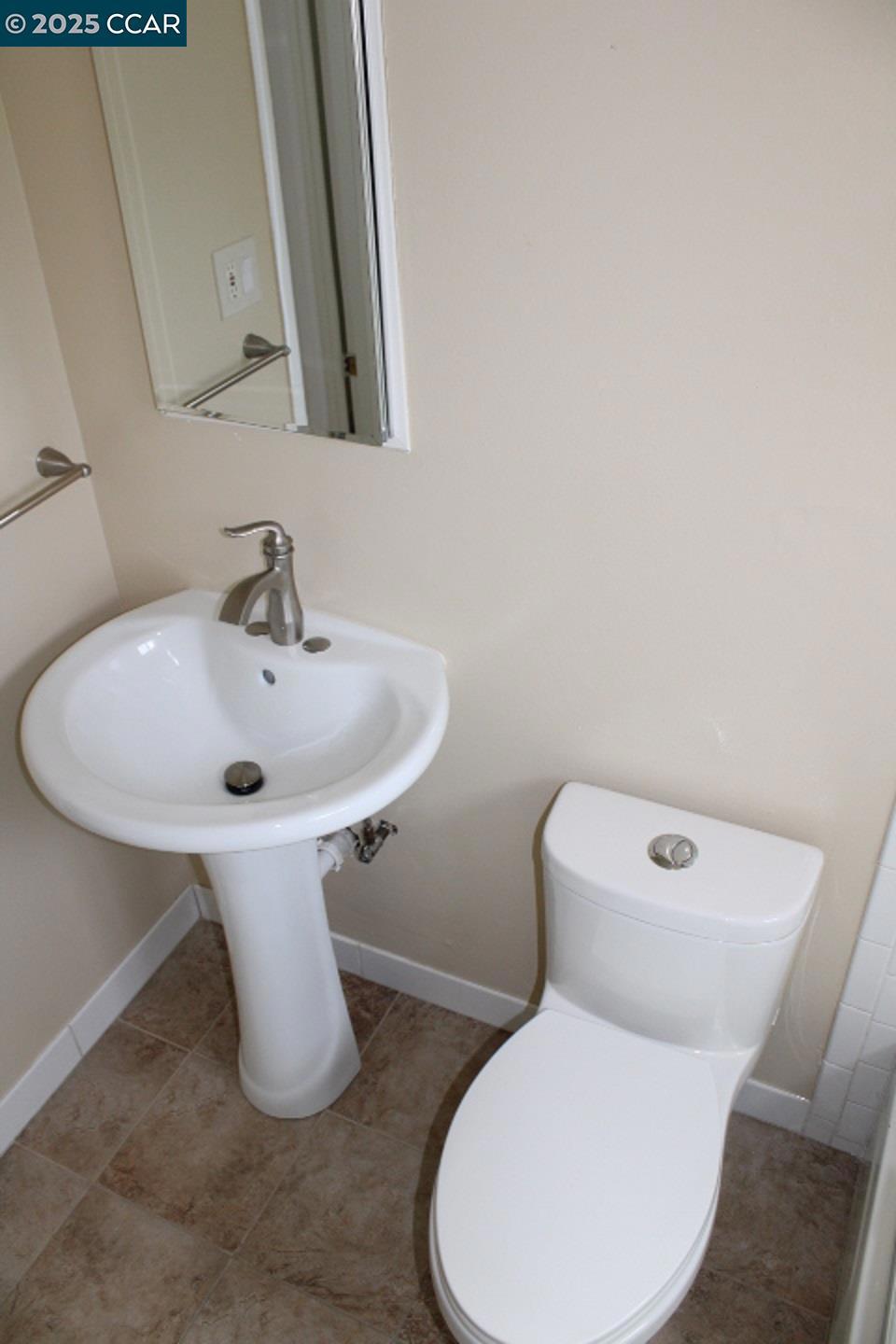 2292 Orleans Drive Pinole, CA 94564 - Photo 12 of 16 a white toilet sitting next to a bathroom sink