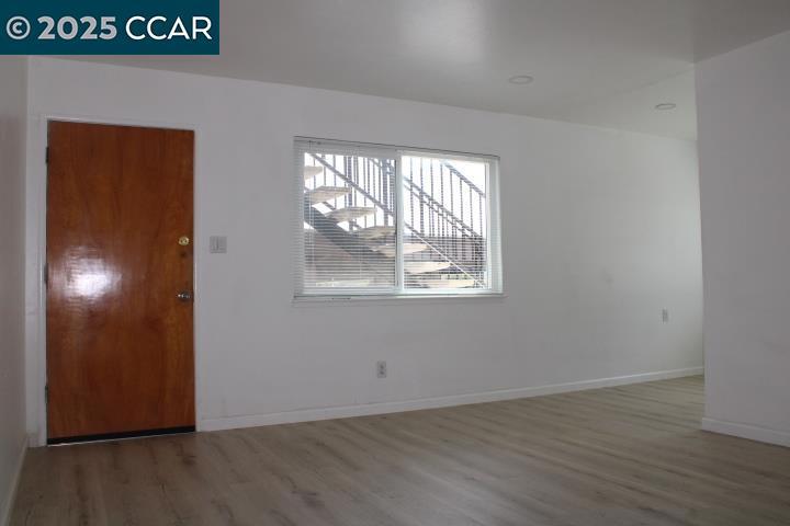 2292 Orleans Drive Pinole, CA 94564 - Photo 3 of 16 an empty room with wooden floor and windows