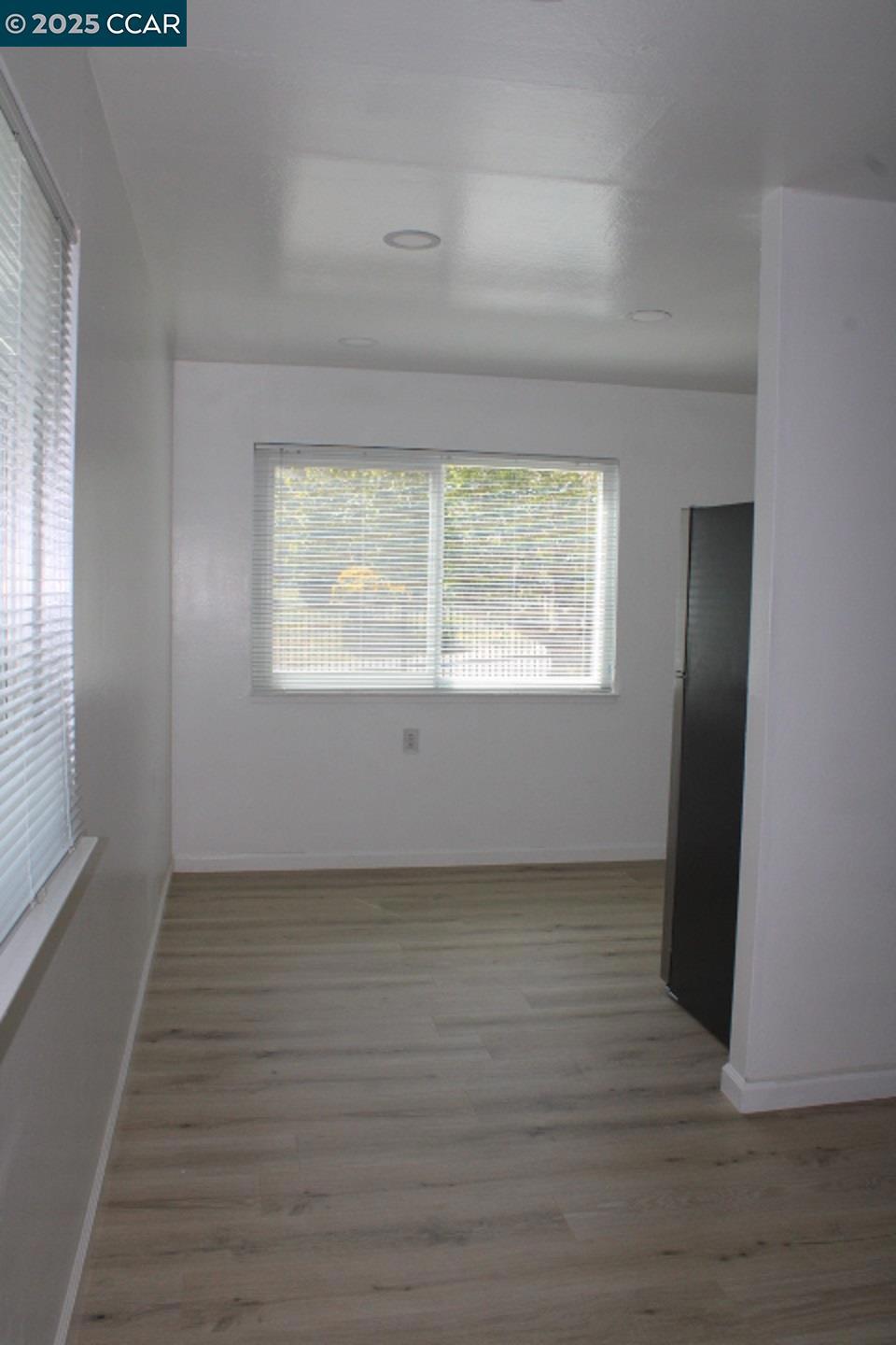 2292 Orleans Drive Pinole, CA 94564 - Photo 4 of 16 an empty room with wooden floor and windows