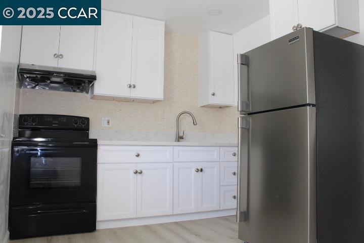 2292 Orleans Drive Pinole, CA 94564 - Photo 5 of 16 a kitchen with a refrigerator and a sink