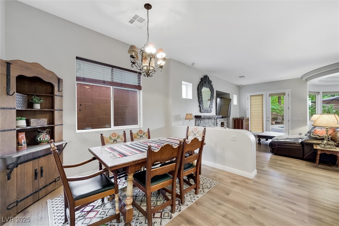 10720 Elm Ridge Avenue Las Vegas, NV 89144 - Photo 22 of 67 Dining area featuring light wood finished floors and a chandelier