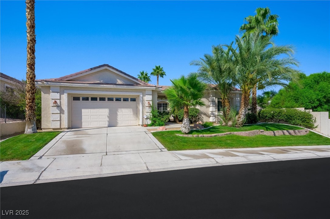 10720 Elm Ridge Avenue Las Vegas, NV 89144 - Photo 3 of 67 Ranch-style home featuring driveway, a garage, and stucco siding