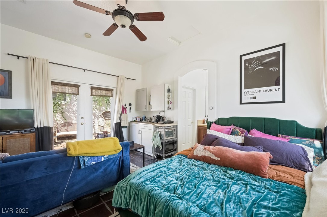 10720 Elm Ridge Avenue Las Vegas, NV 89144 - Photo 45 of 67 Bedroom featuring access to exterior, dark tile patterned floors, a ceiling fan, french doors, and arched walkways