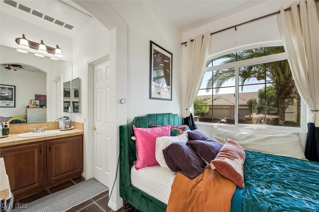 10720 Elm Ridge Avenue Las Vegas, NV 89144 - Photo 46 of 67 Bedroom featuring dark tile patterned floors and a sink