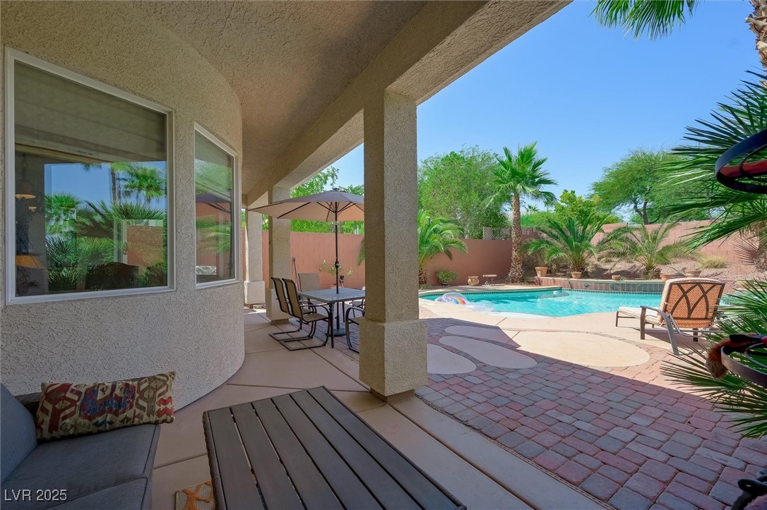 10720 Elm Ridge Avenue Las Vegas, NV 89144 - Photo 47 of 67 View of swimming pool with a patio area, a fenced backyard, and outdoor dining area