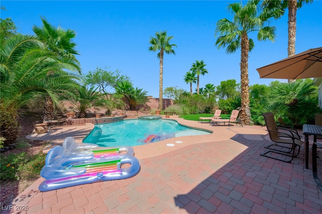 10720 Elm Ridge Avenue Las Vegas, NV 89144 - Photo 48 of 67 View of swimming pool featuring a patio, a pool with connected hot tub, and a fenced backyard